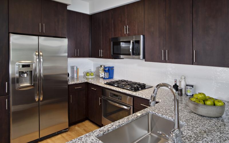 a kitchen with wooden cabinets