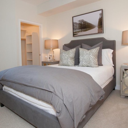a bedroom with a bed and lamps