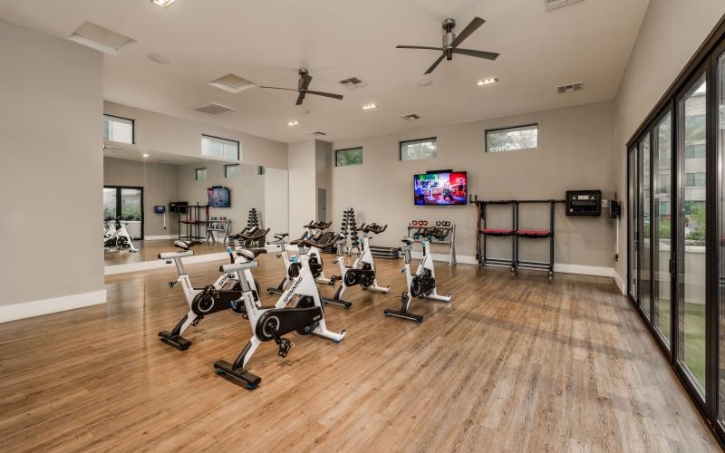 a room with a few stationary bikes